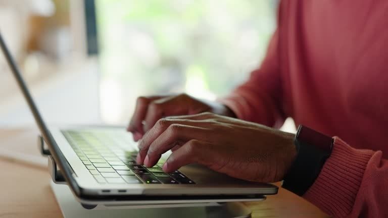 Person typing on a laptop, illustrating digital newsroom research