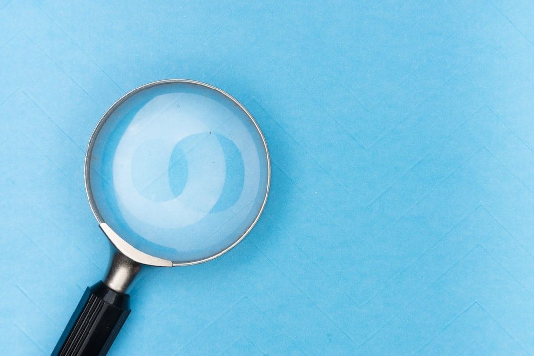 Magnifying glass on a blue surface, symbolizing fact-checking